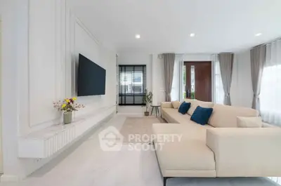 Spacious modern living room with elegant decor and large windows for natural light.