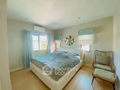 Cozy bedroom with modern decor and ample natural light