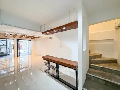 Spacious modern interior with sleek staircase and polished floors, ideal for contemporary living.