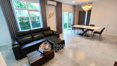 Spacious modern living room with elegant dining area and garden view
