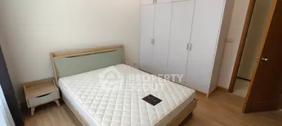 Modern bedroom with sleek wardrobe and cozy bed in a stylish apartment.