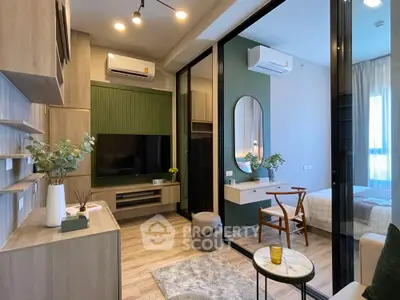 Modern living room with stylish decor and glass partition to bedroom