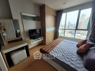 Modern bedroom with city view, featuring stylish decor and large windows for natural light.