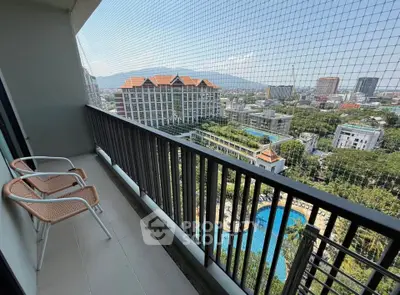 Spacious balcony with stunning city and pool view in modern high-rise apartment.