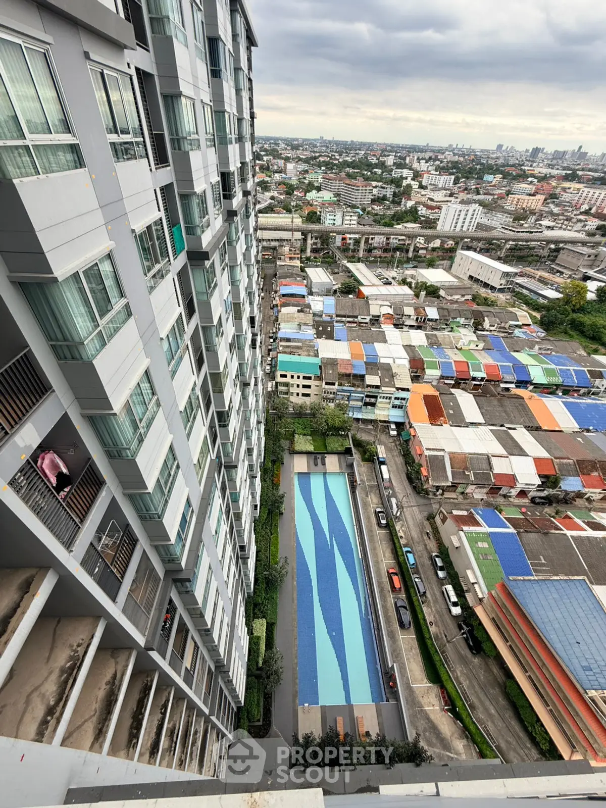 High-rise building with pool and cityscape view from above