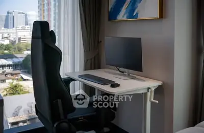 Modern study area with city view, featuring sleek desk and ergonomic chair.