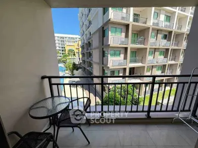 Spacious balcony with pool view in modern apartment complex