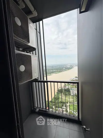 Stunning high-rise balcony view with river and cityscape, featuring modern air conditioning units.