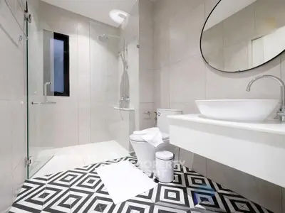 Modern bathroom with geometric floor tiles and sleek fixtures