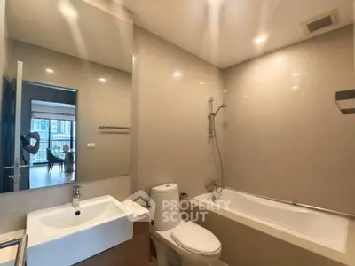 Modern bathroom with bathtub and sleek fixtures in a contemporary apartment.