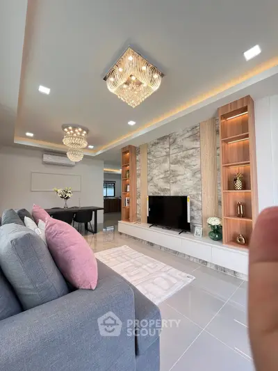 Luxurious modern living room with elegant chandeliers and stylish decor