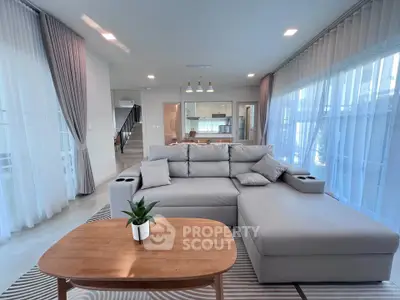 Spacious modern living room with large windows and elegant decor