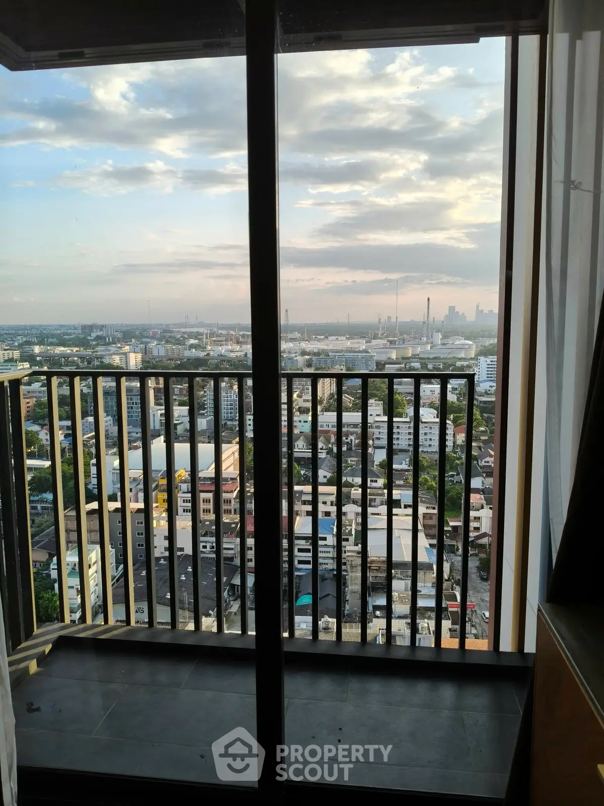 Stunning cityscape view from a high-rise balcony with expansive skyline.