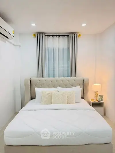 Elegant bedroom with plush bed and soft lighting, perfect for relaxation.
