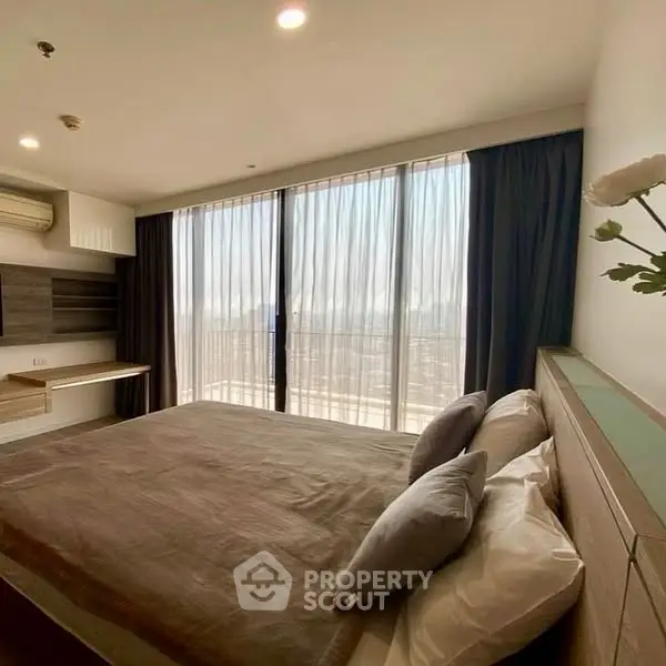 Modern bedroom with large windows and stylish decor