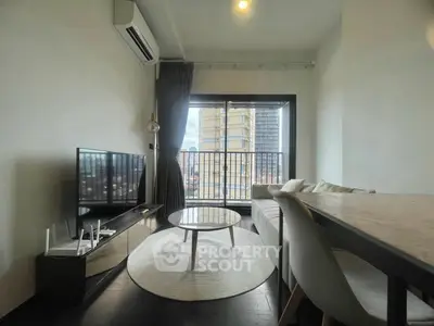 Modern living room with balcony view, sleek furniture, and natural light.