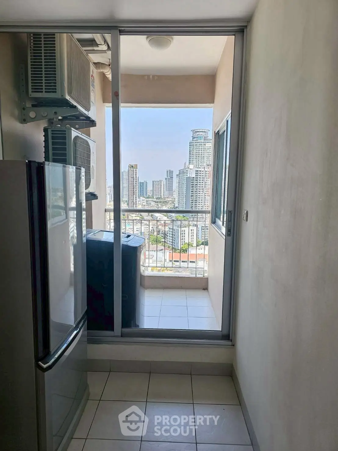 Modern apartment with balcony offering stunning city skyline views, featuring sleek appliances and ample natural light.