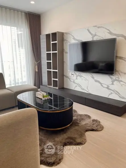 Modern living room with marble accent wall and sleek furniture in a high-rise apartment.