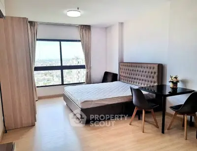 Spacious modern bedroom with city view, featuring elegant furniture and natural light.