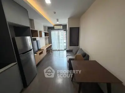 Modern living room with sleek furniture and natural light, perfect for urban living.