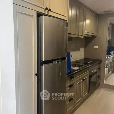 Modern kitchen with stainless steel fridge and sleek cabinetry
