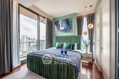 Luxurious bedroom with city view, modern decor, and elegant furnishings in high-rise apartment.
