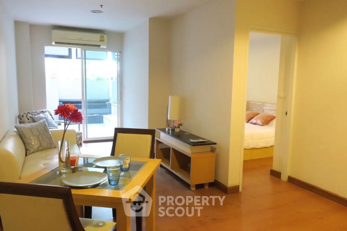 Charming apartment with cozy living room and balcony access, perfect for urban living.