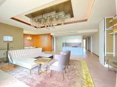 Luxurious open-plan living room with modern furniture and elegant lighting in a high-end apartment.