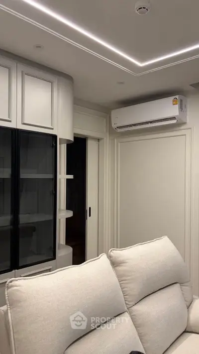 Modern living room with sleek cabinetry and air conditioning unit