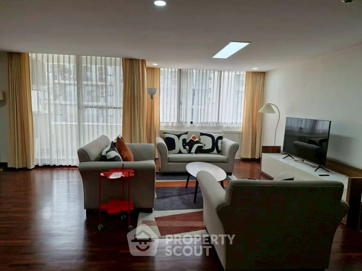 Spacious living room with modern furniture and large windows for natural light.