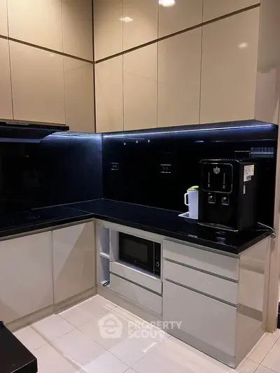 Modern kitchen with sleek cabinetry and built-in appliances