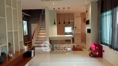 Spacious modern living room with open kitchen and stylish staircase