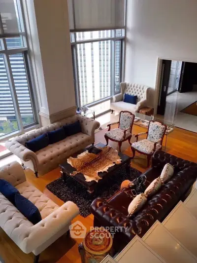 Luxurious high-rise living room with elegant furniture and floor-to-ceiling windows offering city views.
