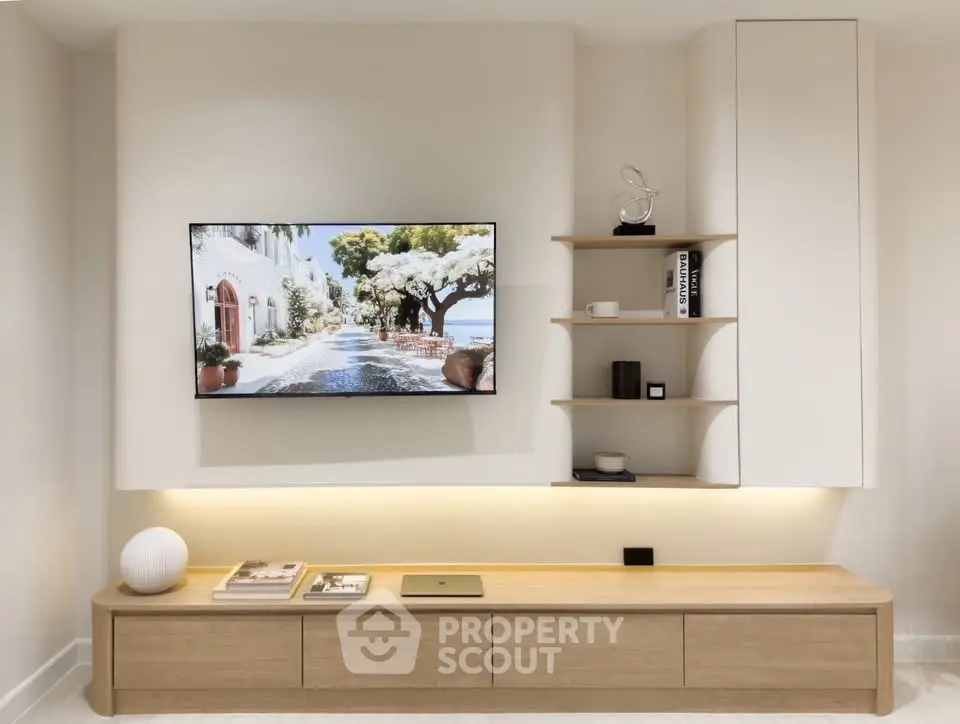Modern living room with sleek TV setup and stylish shelving