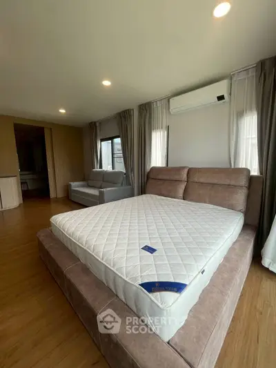 Spacious bedroom with modern furnishings and natural light