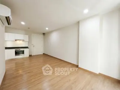 Spacious modern living room with open kitchen and wooden flooring