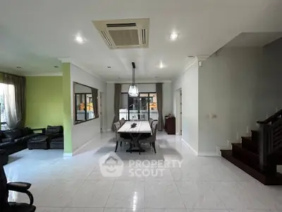 Spacious open-plan living and dining area with modern furnishings and natural light.