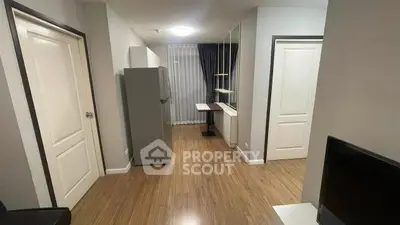 Modern apartment interior with sleek wooden flooring and contemporary furnishings.