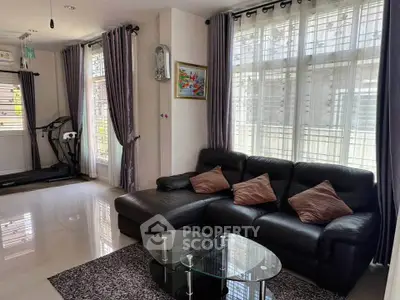 Spacious living room with modern decor and large windows for natural light