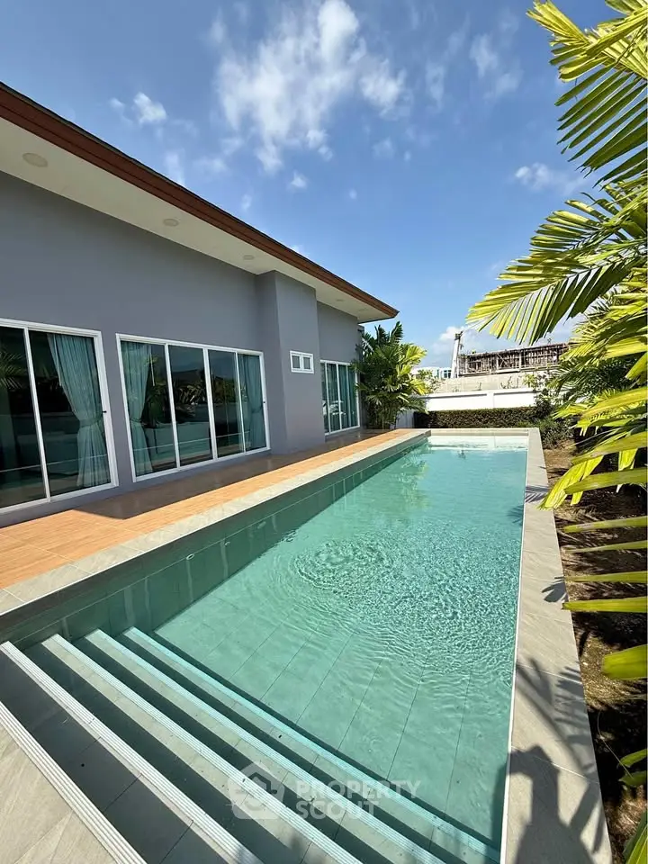Luxurious modern home with private pool and lush greenery, perfect for relaxation and entertainment.