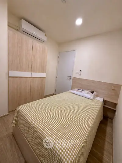 Cozy bedroom with modern air conditioning and stylish wardrobe, perfect for comfort and relaxation.