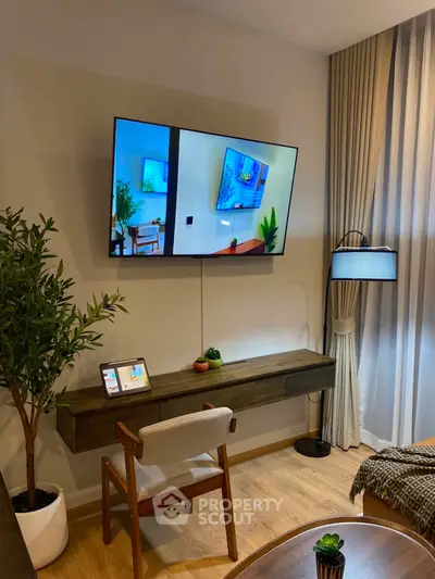 Modern living room with wall-mounted TV, stylish furniture, and elegant decor
