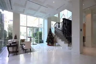 Luxurious living room with grand staircase and festive decor