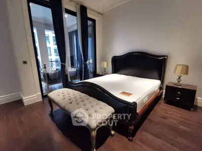 Luxurious bedroom with elegant dark wood flooring and stylish furnishings