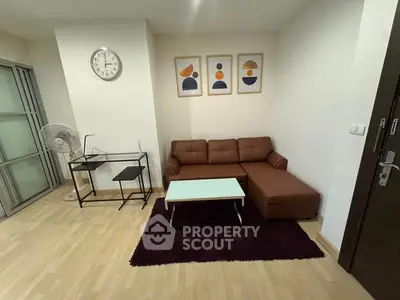 Cozy living room with modern decor and comfortable seating in a stylish apartment.