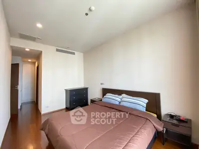 Spacious bedroom with modern furnishings and natural lighting