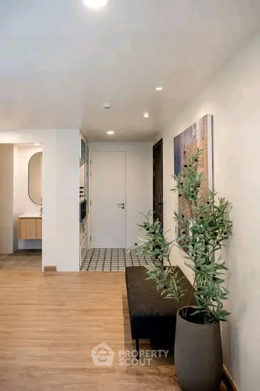 Modern apartment hallway with stylish decor and wooden flooring