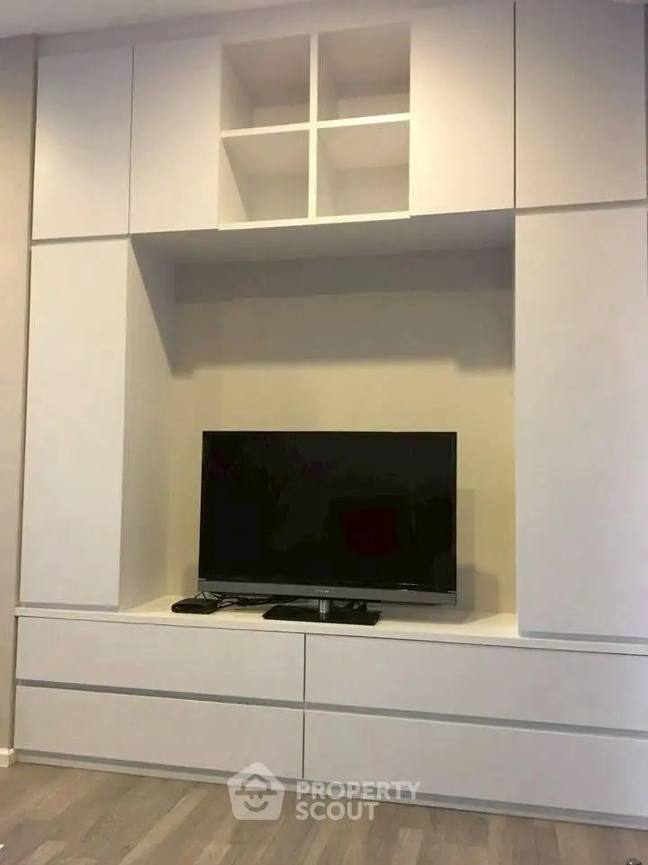 Modern living room with sleek TV cabinet and ample storage space.