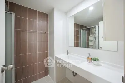 Modern bathroom with sleek design and large mirror in contemporary apartment.