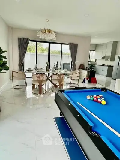 Luxurious open-plan living room with pool table and elegant dining area